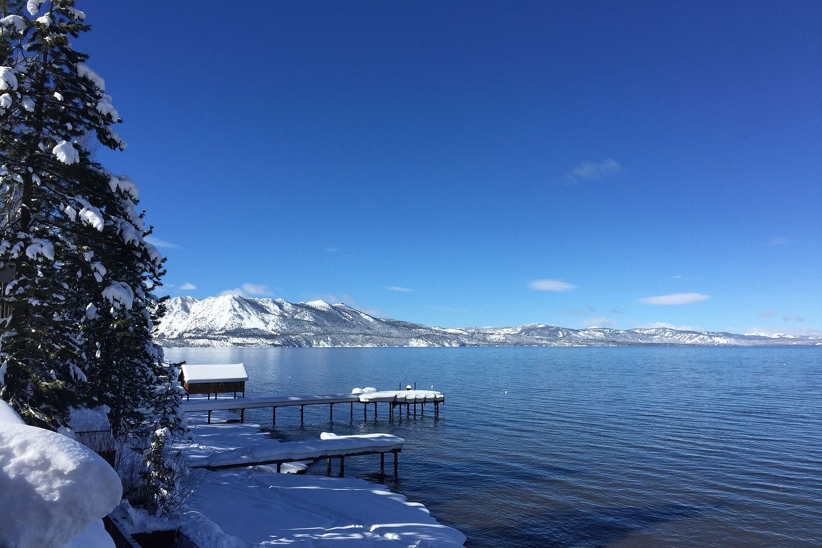 The lakefront and private dock at the Beachcomber Inn under fresh snow.