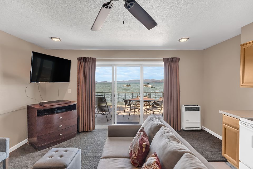Living room and the slider to the lake-view deck, Unit A at the Beachcomber Inn