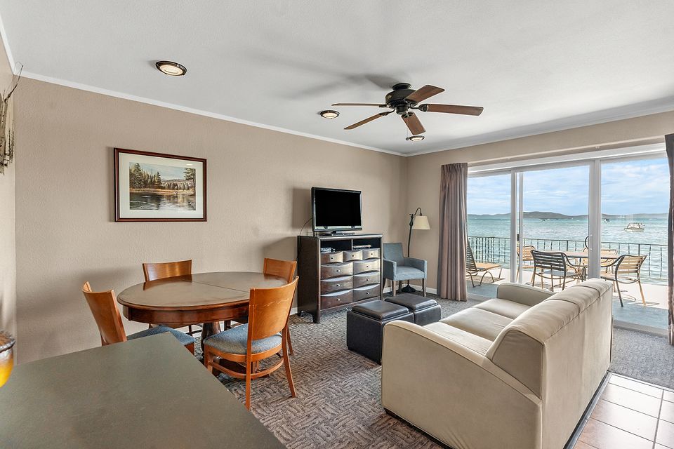 Dining table and living room with a view of Lake Tahoe, Unit C at the Beachcomber Inn