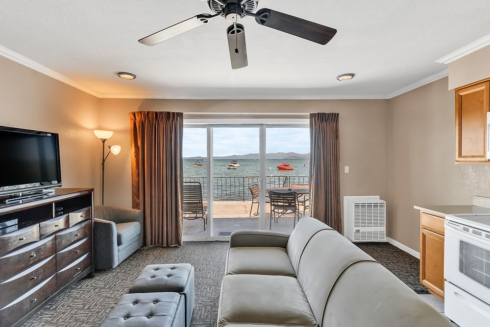 Living room and the slider to the lake-view deck, Unit E at the Beachcomber Inn