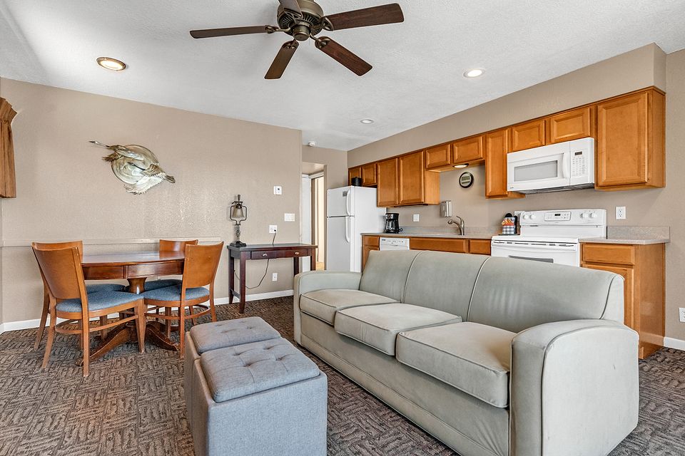 Dining table and living room, Unit F at the Beachcomber Inn