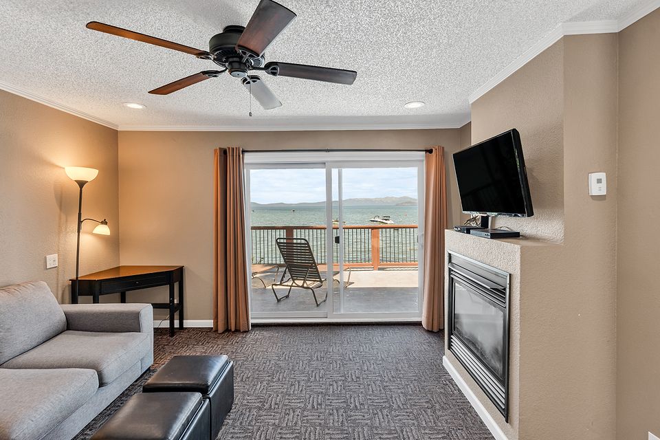Living room with the fireplace and the slider to the deck, Unit G at the Beachcomber Inn