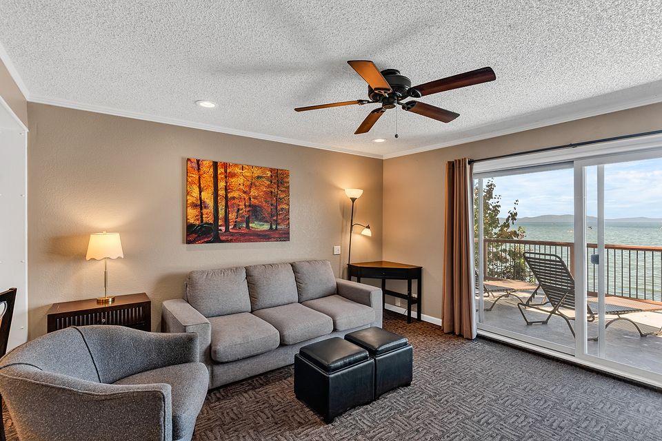 Living room sofa with the lake through the slider, Unit G at the Beachcomber Inn