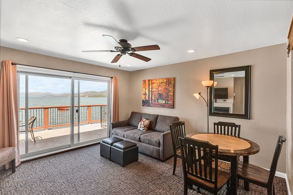 Living room and dining table with a view of Lake Tahoe, Unit H at the Beachcomber Inn