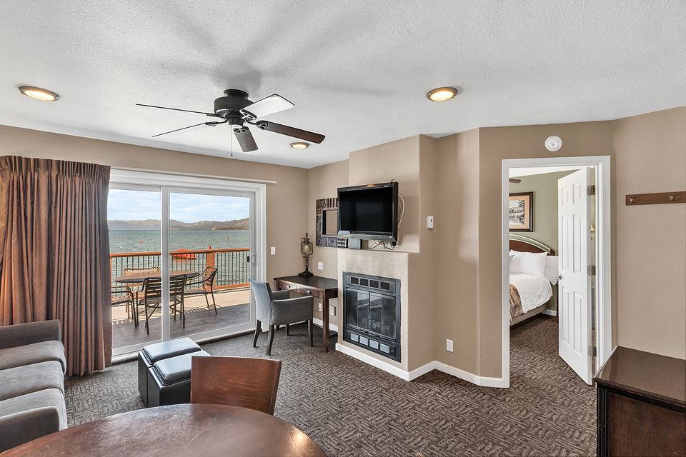 Living room with the fireplace and a view of Lake Tahoe, Unit I at the Beachcomber Inn