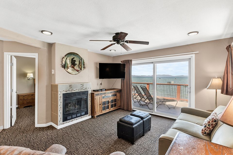 Gas fireplace, TV, and the slider to the deck, Unit J at the Beachcomber Inn