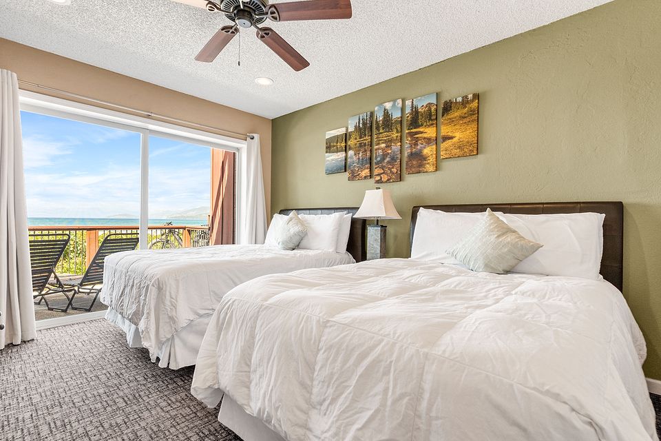 Bedroom with two beds and a view of Lake Tahoe, Unit L at the Beachcomber Inn