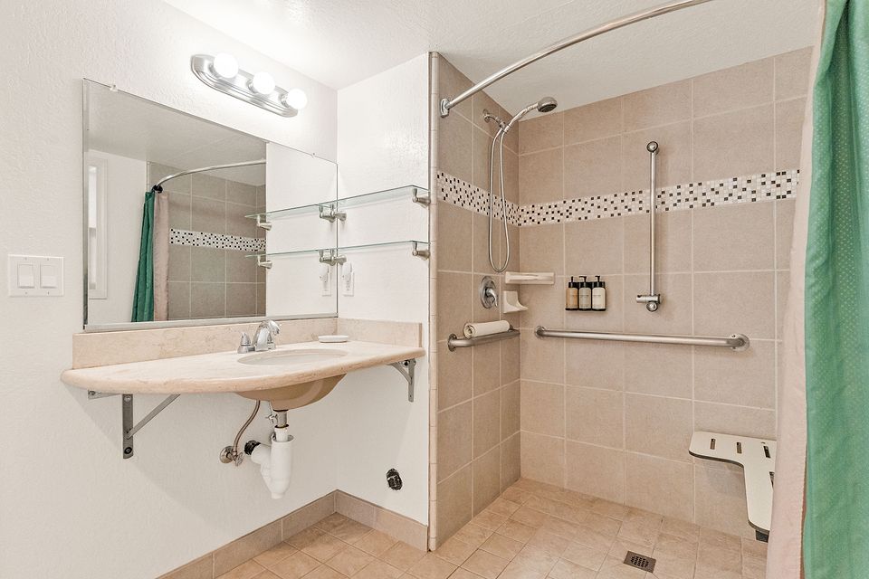 Second bathroom with a roll-in shower and grab bars, Unit L at the Beachcomber Inn