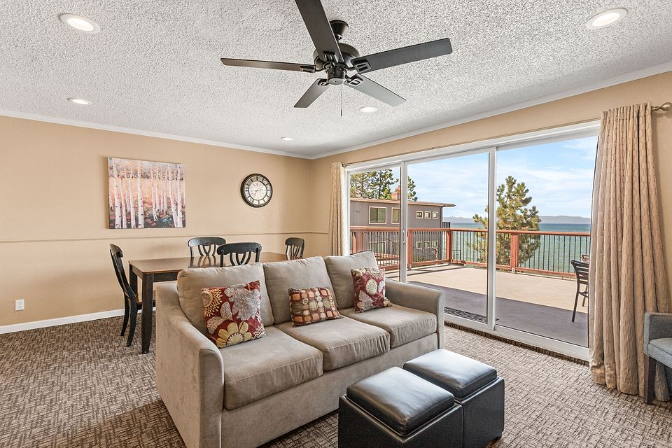 Living room, dining table, and the slider to the deck, Unit M at the Beachcomber Inn