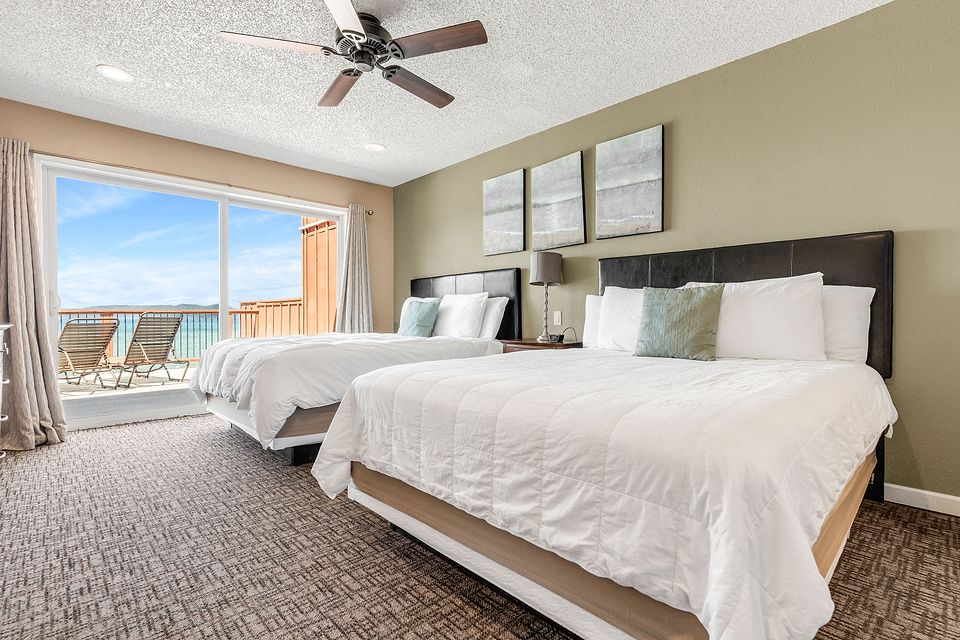 Bedroom with two beds and a view of Lake Tahoe, Unit M at the Beachcomber Inn