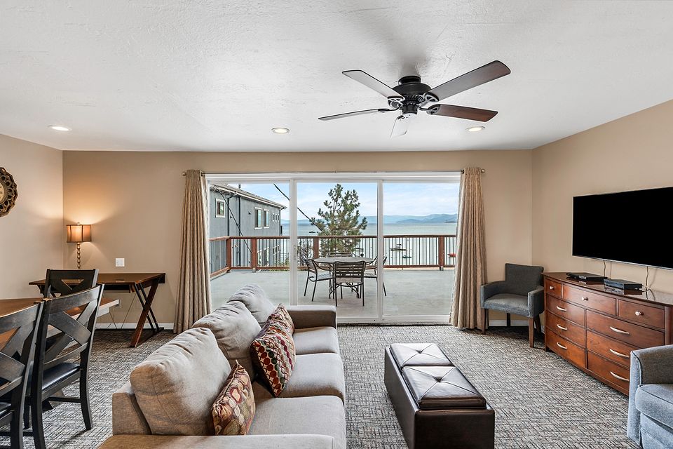 Living room and the slider to the lake-view deck, Unit N at the Beachcomber Inn