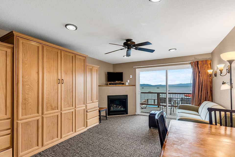 Studio living area with a gas fireplace and a Lake Tahoe view, Unit O at the Beachcomber Inn