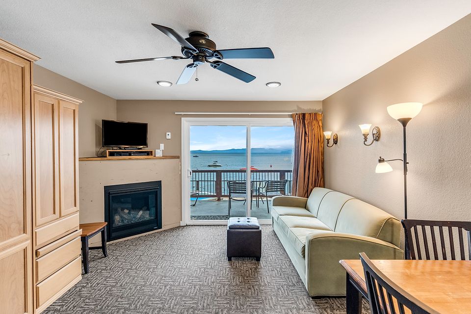 Sofa, fireplace, and the slider to the deck, Unit O at the Beachcomber Inn