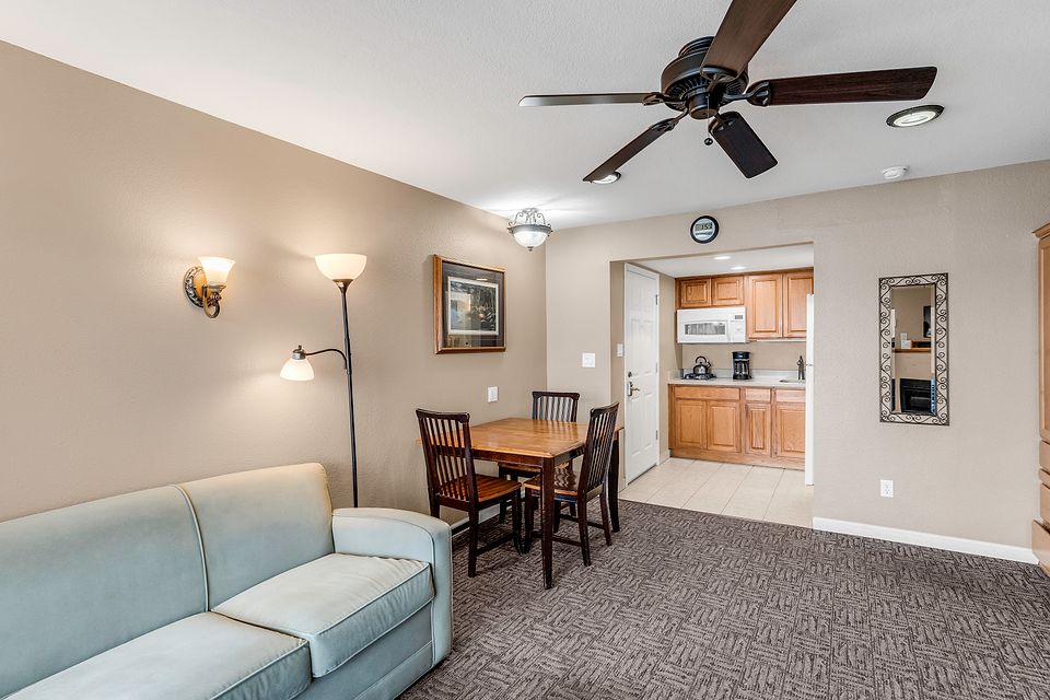 Sofa, dining table, and the kitchen, Unit O at the Beachcomber Inn