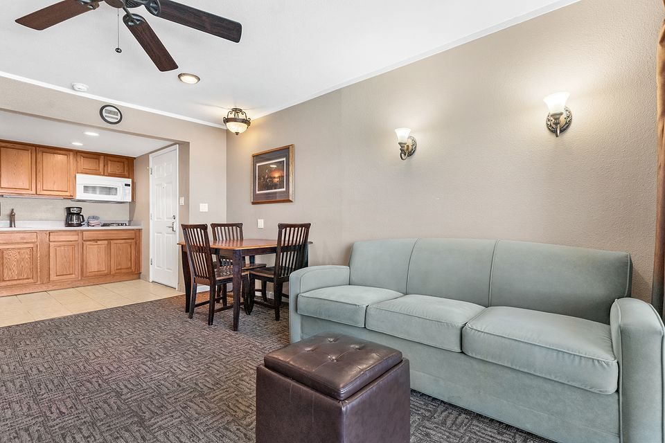 Sofa, dining table, and the kitchen, Unit P at the Beachcomber Inn