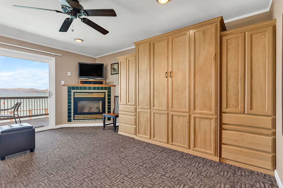 Wall bed cabinet, fireplace, and the slider to the deck, Unit P at the Beachcomber Inn