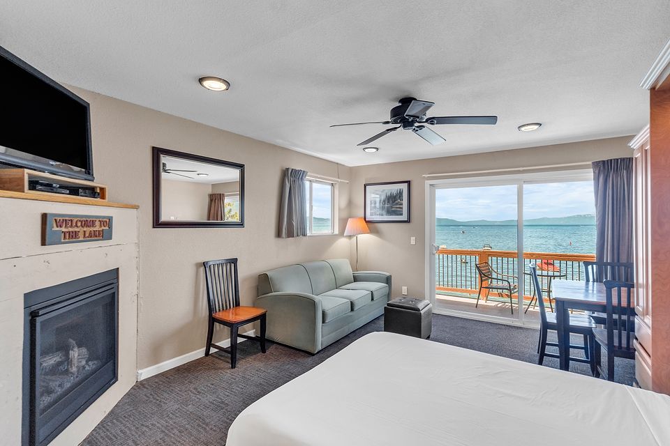 Gas fireplace, sofa, and the lake through the slider, Unit R at the Beachcomber Inn