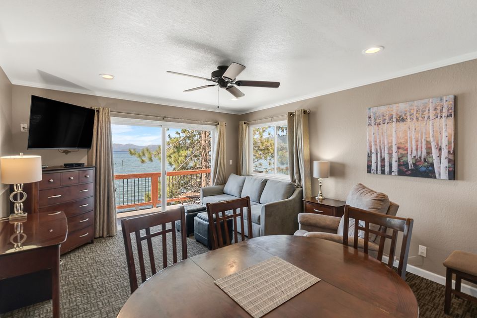 Dining table and living room with a view of Lake Tahoe, Unit T at the Beachcomber Inn